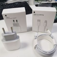 an apple charger and power adapter are sitting on a desk next to the box