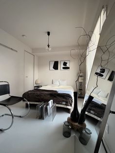 an image of a modern bedroom setting with mirrors and lights on the wall, as well as a bed