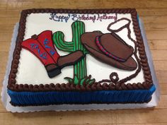 a birthday cake with a cowboy hat and boots on it