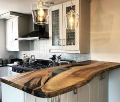 a wooden counter top sitting in the middle of a kitchen