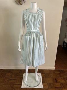 For your consideration Vintage Shane Uniforms pinafore striped nurse uniform dress. 2 big hip pockets. 100% cotton. Made in USA. Marked size 14 or 32 bust Fits like modern S - would work on XS too Pre owned, shows general wear. Overall nice dress. Slight fade. Has yellowing and discoloration in areas but doesn't really read unless up close. Normal surface wear. Missing one button at waist. Sold as is. Shown on size small mannequin Please review photos to best determine condition and message with Vintage Smock Dress For Daywear, Fitted Vintage Smock Dress, Fitted Smock Vintage Dress, Vintage Smocked Fitted Dress, Fitted Cotton Dress With Bib Front, Knee-length Lined Vintage Dress For Daywear, Vintage Daywear Dresses With Pockets, Vintage Knee-length Dresses With Pockets, 40s Costume