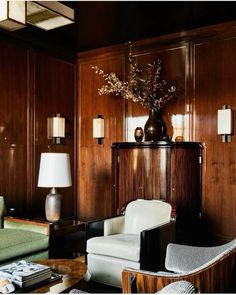 a living room filled with furniture and wooden walls