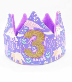 a purple and gold crown with the number 3 on it