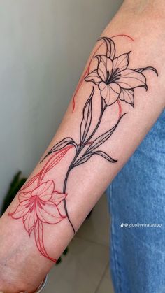 a woman's arm with a flower tattoo on the left side of her arm