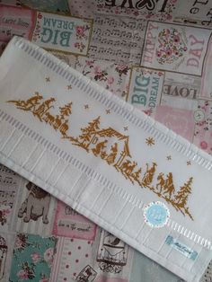 the fabric has been sewn together and is white with gold trimmings on it