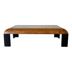 a wooden table with black legs and a glass top