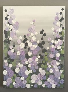 a painting with flowers painted on it in purples and white, hanging on a wall