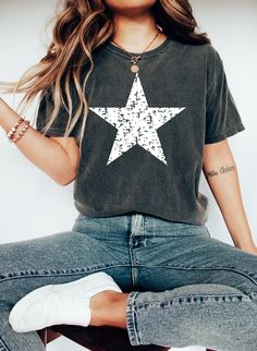 Distressed Star Comfort Colors Shirt, Big Star t-shirt, 4th of July shirt, Patriotic shirt, Memorial Day, Women, Men's Star Tee, America 🎈WELCOME TO UNIQUE TRENDS DESIGN  If you are looking for soft, comfy, first-rate t-shirts, you're in the right place! Here at Unique Trends Design, we love what we do and strive to make your shopping experience just right for you. If you have any questions, concerns, or comments about our products, feel free to shoot us a message anytime. Even on weekends and holidays, we'll try our best to respond as quickly as possible! 🎈Product Details  Unisex T-Shirt: - Comfort Colors Brand - 100% cotton - Light/medium weight and extremely soft, this shirt is sure to be your next favorite t-shirt. 🎈Sizing and Coloring  Please make sure you select the right color an Crew Neck Tops With Star Logo For Summer, Casual Tops With Star Logo And Relaxed Fit, Relaxed Fit Short Sleeve Tops With Star Logo, Cotton Crew Neck Top With Star Patch, Casual Crew Neck T-shirt With Star Patch, Black Crew Neck Top With Star Patch, Relaxed Fit Graphic Tee With Star Print, Short Sleeve Cotton Top With Star Print, Cotton Short Sleeve Tops With Star Print