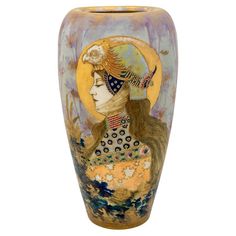 a vase with a woman's face painted on the front and sides, sitting against a white background