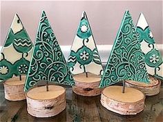 small green christmas trees sitting on top of wooden logs