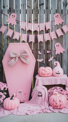 a pink halloween party with pumpkins and decorations