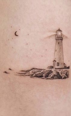 a tattoo with a lighthouse on it