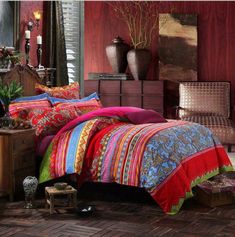 a bed room with a neatly made bed next to a dresser and window filled with vases