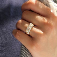 a woman's hand with a diamond ring on it