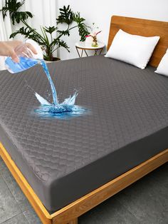 a person is pouring water into a bed