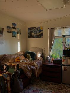 a messy bedroom is shown with pictures on the wall and other things in the room