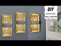 two gold framed pictures hanging on the wall next to each other with text overlay saying diy high - end wall lighting