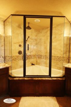 a walk in shower sitting next to a bath tub