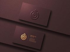 two business cards with the letter g on them, one is gold and the other is black