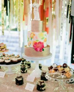 a table topped with lots of cupcakes and cakes