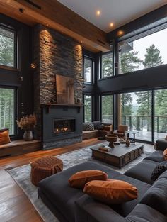 a living room filled with lots of furniture next to a fire place and large windows