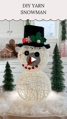 a snowman made out of yarn sitting on top of a table