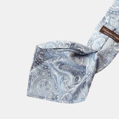 Inspired by the iconic Casino de Monte-Carlo, featured in James Bond novels and films, I designed this Montecarlo tie for those who appreciate timeless sophistication. Handmade from luxurious, heavy-weight silk, it features a woven paisley motif in light blue, making it perfect for any distinguished event. Why settle for ordinary when you can have extraordinary? Details Standard Length: Approx. 3.25" x 58.5" (8 x 149cm). A classic tie width and length that is perfect for most men up to 6'2" (188 Luxury Silk Neckwear For Business, Luxury Blue Silk Ties, Formal Blue Silk Neckwear, Luxury Silk Neckwear For Formal Occasions, Blue Silk Neckwear For Formal Occasions, Luxury Silk Ties For Semi-formal Occasions, Luxury Silk Tie, Luxury Silk Ties, Silk Neckwear With Pocket Square For Formal Occasions