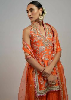 A halter neck kurta with eye catching embroidery suitable for any occasion. Adorned with gota and threadwork. Orange Dori Work Sharara For Festivals, Bollywood Style Orange Sets With Gota Work, Orange Gota Work Dress For Festivals, Semi-stitched Orange Sharara With Dori Work, Fitted Orange Sharara With Gota Work, Suit Neck Designs, Sharara Designs, Haldi Outfits, Diwali Outfits