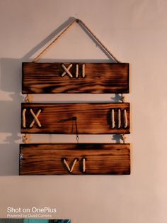 two wooden signs hanging on the wall with numbers and letters attached to them that say x, y