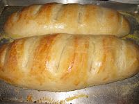 two loaves of bread sitting on top of a pan