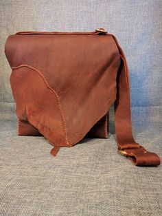 Rustic Brown Leather SatchelThis particular bag is SOLD. We are happy to make you a similar onePractical purse, handbag, cross body, tablet, unisex, messenger, or shoulder bag. This bag is made from a rustic kodiak tanned leather. It has been treated with oils and waxes to make it durable and waterproof.  It is hand stitched with nylon waxed thread. The stress points are reinforced with rivets and the strap is adjustable between  one shoulder and across the body.The bag measures roughly 10 in by Rustic Satchel For Travel, Rustic Handmade Bags For Daily Use, Rustic Travel Satchel Bag, Rustic Bags With Leather Lining For Everyday Use, Rustic Leather-lined Bag For Everyday Use, Rustic Crossbody Bag For Everyday Use, Rustic Brown Crossbody Bag, Rustic Everyday Bags With Leather Lining, Rustic Handmade Shoulder Bag For Everyday Use