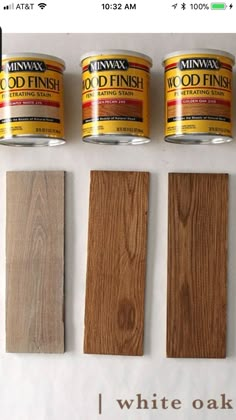 three cans of wood paint next to two wooden planks with the words white oak painted on them