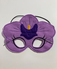 "Great for dramatic play/dress-up. Fun mask for Halloween or Cos Play. These masks would make a fun party favor or fun addition to a themed birthday party. You could pair them with your favorite book for a fun gift. Need a larger quantity than what I have listed? Message me. I can usually accommodate larger orders. These masks are made from felt. The details are machine embroidered. The masks include a 13\" elastic strap. This size typically fits from age 3 to small adult. This mask measures app Themed Purple Costumes For Costume Party, Purple Fantasy Costume For Party, Fantasy Purple Costume For Party, Mardi Gras Novelty Costume Accessories For Costume Party, Novelty Costume Accessories For Mardi Gras, Purple Themed Party Costume Accessories, Purple Mardi Gras Costume Accessories, Halloween Birthday Party Favors, Pretend Play Costumes