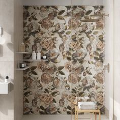 a bath room with a toilet and a flowered wall paper on the shower stall