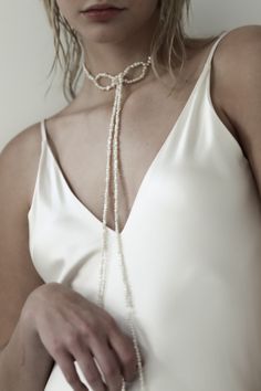 Not your grandma’s pearl necklace— asymmetrical strands of freshwater pearls are knotted into a choker for a dramatic yet iconic vintage moment. Editorial and glam— the perfect accessory to add a touch of fluidity and drama. #authentic #smallbusiness #readytowear #datenightinspo #datenightoutfit #accessories #boldearrings #aesthetic #nostalgicaesthetic Elegant Single Strand Round Beads Choker, Elegant Baroque Pearl Choker, Elegant Beaded Pearl Pendant Choker, Elegant Beaded Choker With Pearl Pendant, Elegant Beaded Choker Necklace With Pearl Pendant, Formal Beaded Pearl Choker Necklace, Chic Pearl Choker For Wedding, Elegant Baroque Pearl Lariat Necklace, Elegant Adjustable Pearl Choker