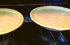 two pies sitting on top of an oven rack