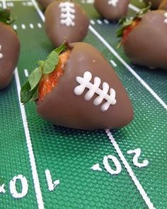 chocolate covered strawberries are arranged on a football field