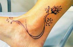 a woman's foot with a flower tattoo on it