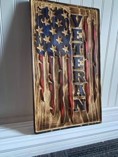 an american flag made out of metal with the words veteran painted on it in gold