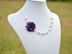 "The listing is for 1 necklace with free matching pearls earrings. There are 3 colors to choose from . Lavender. Violet. Deep Purple. Material and size : Dahlia Flower is approximately 1.5 inches. 6-8mm offwhite/cream/Ivory pearls (pictured) available in Swarovski Pearls. Please add below link to upgrade. Silver Plated Chain(pictured) . Antique Brass and Glod Plated chain available . The entire length approximately 17 inches with 2 \" extender , if you need to resize the length, please let me kn Purple Flower Necklace For Wedding, Dahlia Necklace, Purple Dahlia, Purple Bridesmaid, Pearls Earrings, Necklace Purple, Purple Necklace, Dahlia Flower, Ivory Pearl