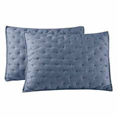 two blue pillows on a white background