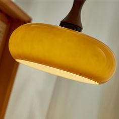 a yellow light hanging from the ceiling in a room