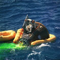 a man riding on the back of an inflatable boat with life rings attached to it