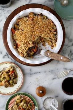 a pie is sitting on a plate next to other dishes