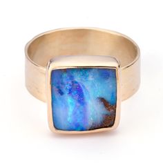 A breathtaking, shimmery boulder opal with an overall periwinkle hue that exhibits bold flashes of electric green, indigo, and aqua. This unique 6 carat gem measures 12.7 x 13.6 mm and is framed in 10k gold with a sterling back. This bold and colorful opal is set on a 10k gold 6 mm wide textured band. Worn alone, or in a stack, this eye catching ring is sure to stand out. Made as a size 8. Please email kate@katedavisjewelry.com if you would like to view additional images or video. Boulder Opal Ring, Electric Green, Opal Ring, Boulder Opal, Opal Rings, 10k Gold, Bouldering, Opal, Gems