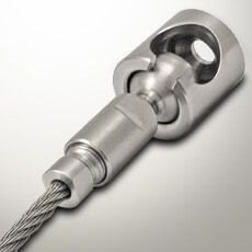 a close up of a metal object on a white surface with a cord attached to it