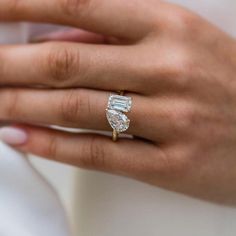 a woman's hand with a diamond ring on it