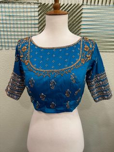 ❥ Handmade Designer stitched blouse ; Can be used for sarees / Lehengas. ❥ Ready to ship (Price mentioned is for Size 34-38)  ❀❀ Return / Exchange Policy :  ※ No Return/ No Exchange / No Cancellation! ※We need proof of video while package is opening for considering any case of missing or damaged products ;  ※ We can not accept any returns , if video at the time of package opening is not provided by the client . ღ ღ Please be courteous and don't ask for negotiation on prices ! We define prices based on material & efforts involved to deliver this high quality product! We use all High Quality handcrafting !  Care Instructions :  1.Dry Wash Only , preserve the blouses in cloth bag to maintain the shine and quality;  NOTE TO OUR BELOVED CLIENTS : We do not buy / sell used items. We do not excha Embroidered Saree Blouse For Wedding, Traditional Fitted Pre-draped Saree With Motifs, Embroidered Wedding Blouse For Saree, Elegant Unstitched Dola Silk Choli, Elegant Mirror Work Blouse Piece For Navratri, Elegant Navratri Blouse Piece With Mirror Work, Semi-stitched Blouse For Wedding Eid, Anarkali Blouse With Dori Work For Wedding, Bollywood Embroidered Blouse For Wedding