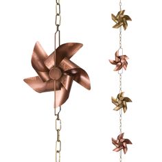 two metal stars hanging from chains on a white background, one is gold and the other is copper