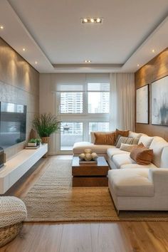 a living room filled with furniture and a flat screen tv sitting on top of a wooden floor